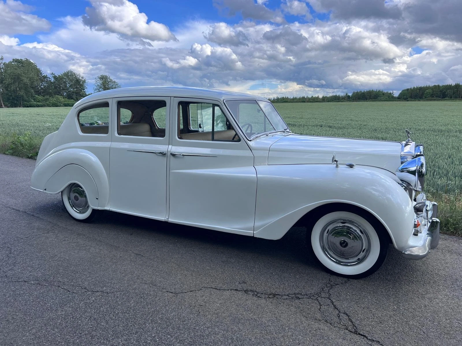 Ice-white classic Lady Bella wedding car side view in Hampshire
